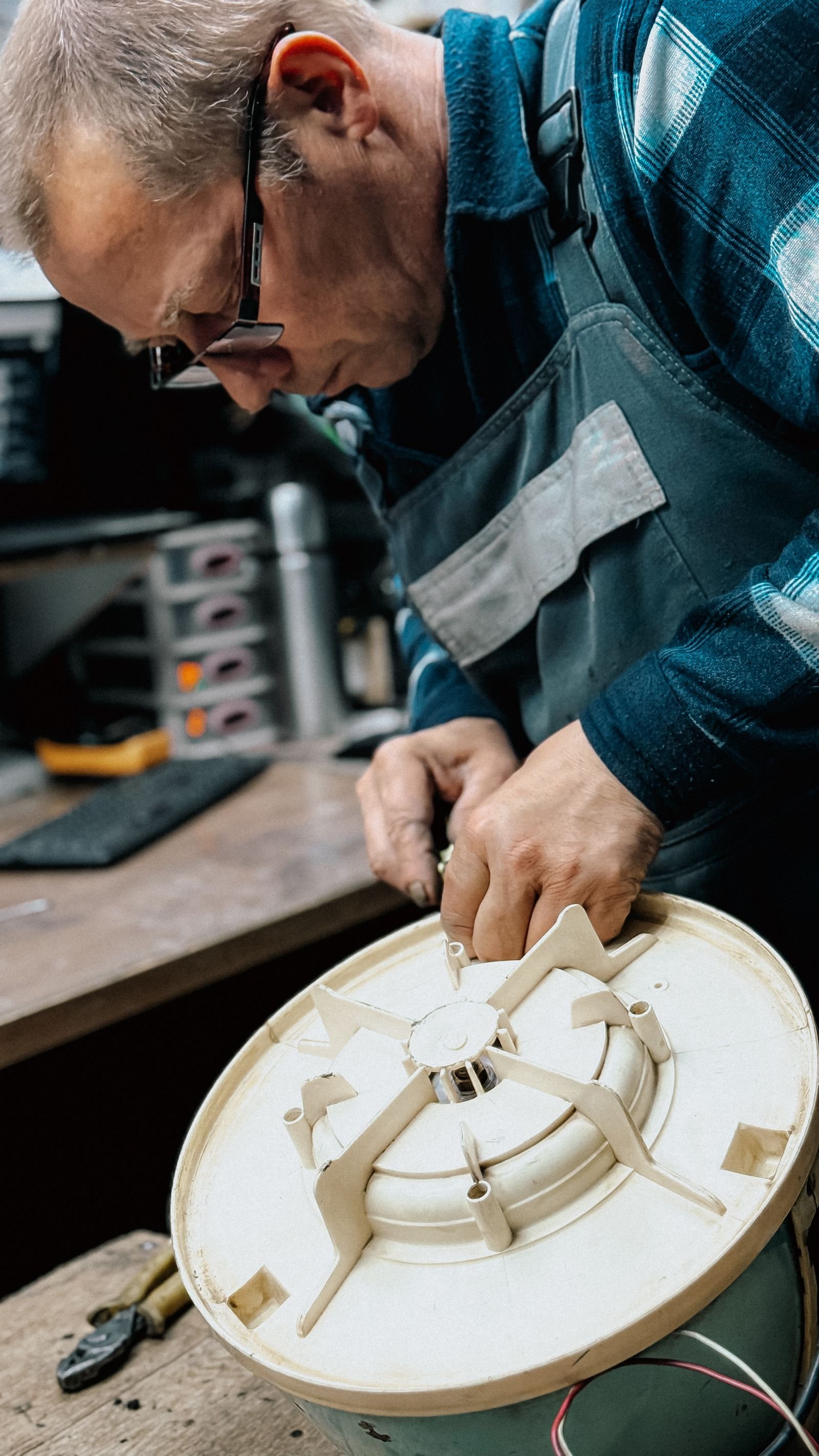 Appliance repair technician fixing a washing machine component